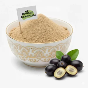 Fine brown Jamun seed powder in an ornate white bowl with a Pansar Essential flag, next to fresh whole and sliced black plums.
