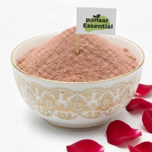 Pansar Essential organic rose petal powder in a decorative white and gold bowl with fresh red rose petals around it.