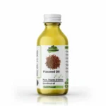 Clear glass bottle of Pansar Essential Organic Cold-Pressed Flaxseed Oil (Roghan Alsi) against a white background.