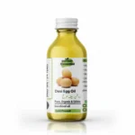A clear glass bottle of Pansar Essential Desi Egg Oil containing golden-green liquid, featuring a label with three eggs, Urdu text, and a product summary against a white background with a shadow.